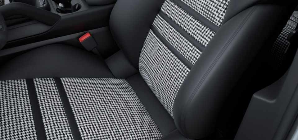 Расширенный частичный кожаный салон черного цвета с тканевой обивкой центральной части сидений.