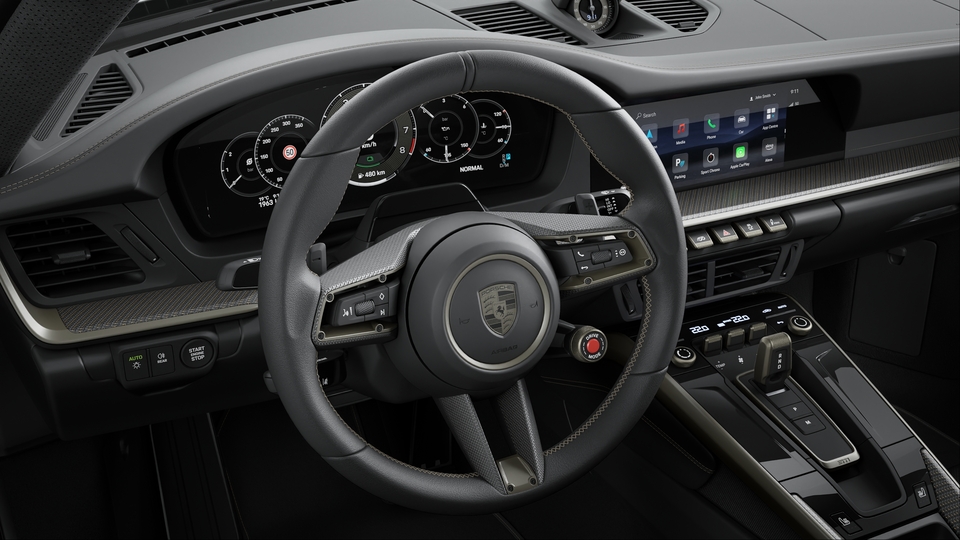 Volante Desportivo GT em Pele com painel em Carbono mate, aquecido (em combinação com o Pacote de Interior em Turbonite)